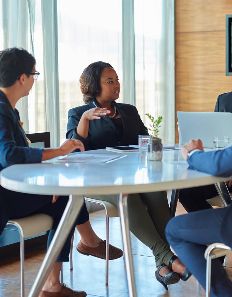 Business leaders in discussion around a meeting table