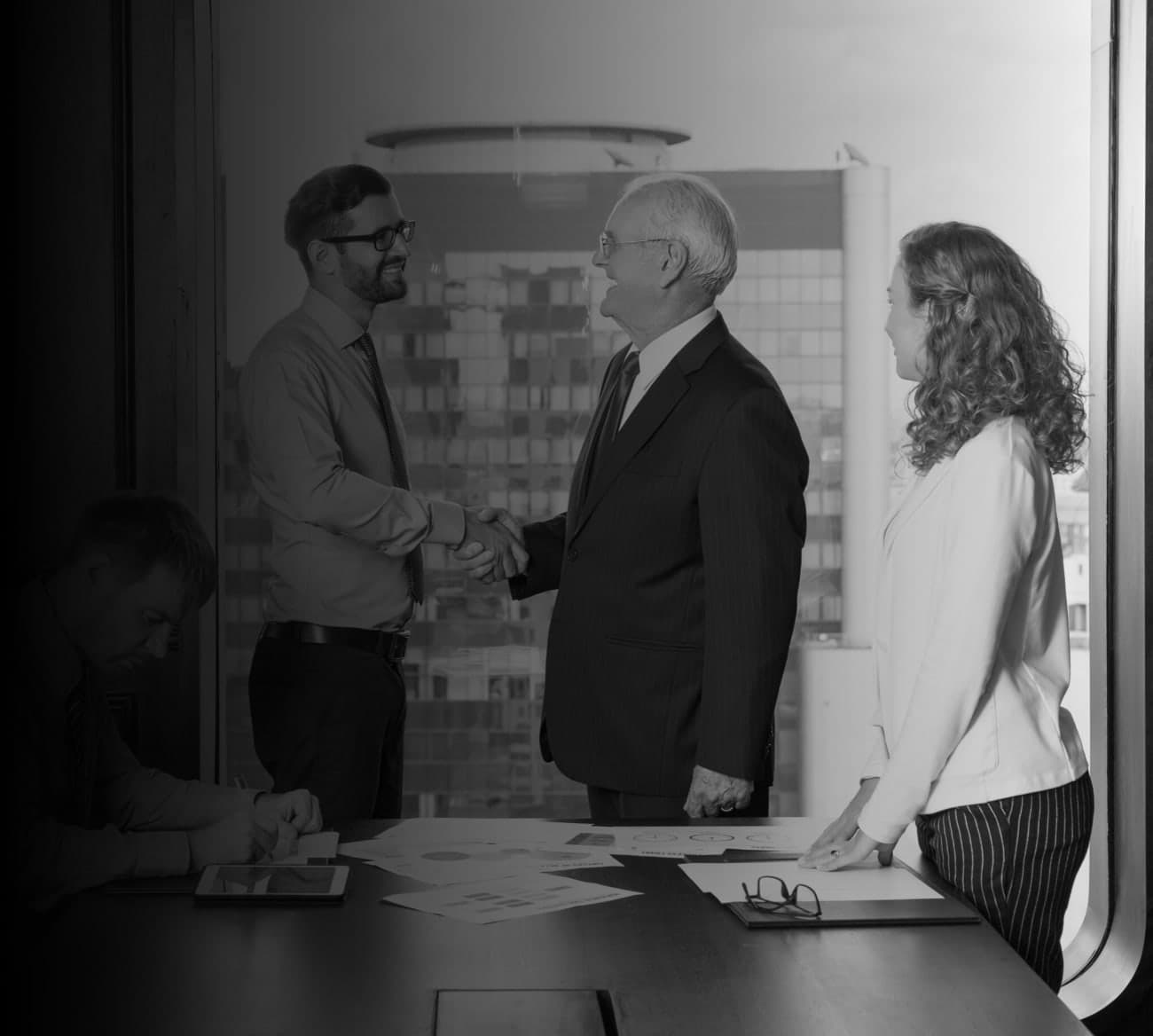 Business leaders shaking hands in a meeting room