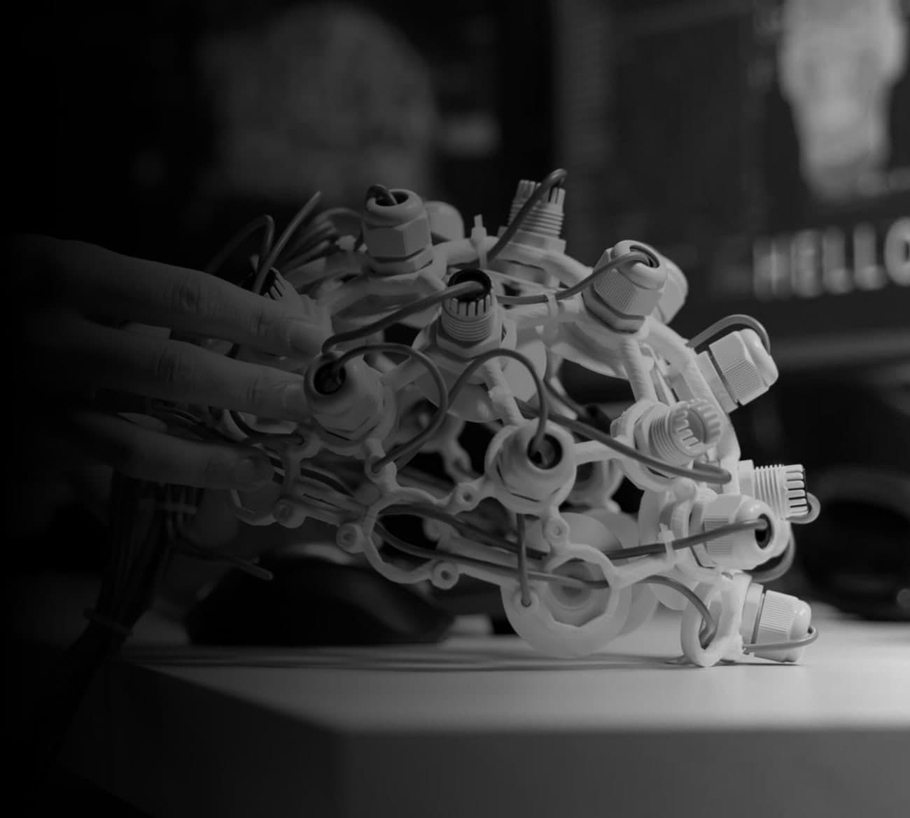 Hands assembling a complex network of connectors