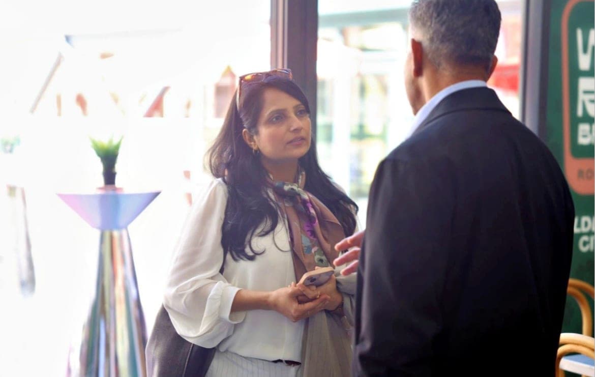 Two attendees in conversation on the sidelines of the Calgary Stampede